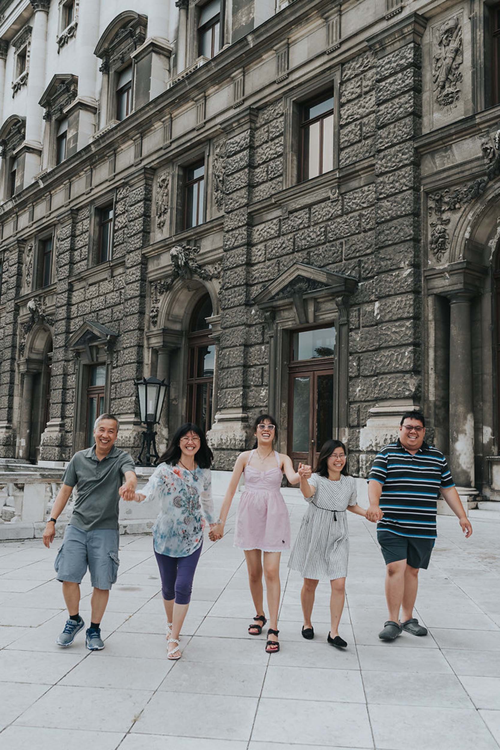 Family holding hands and walking together on a family trip in Vienna, Austria