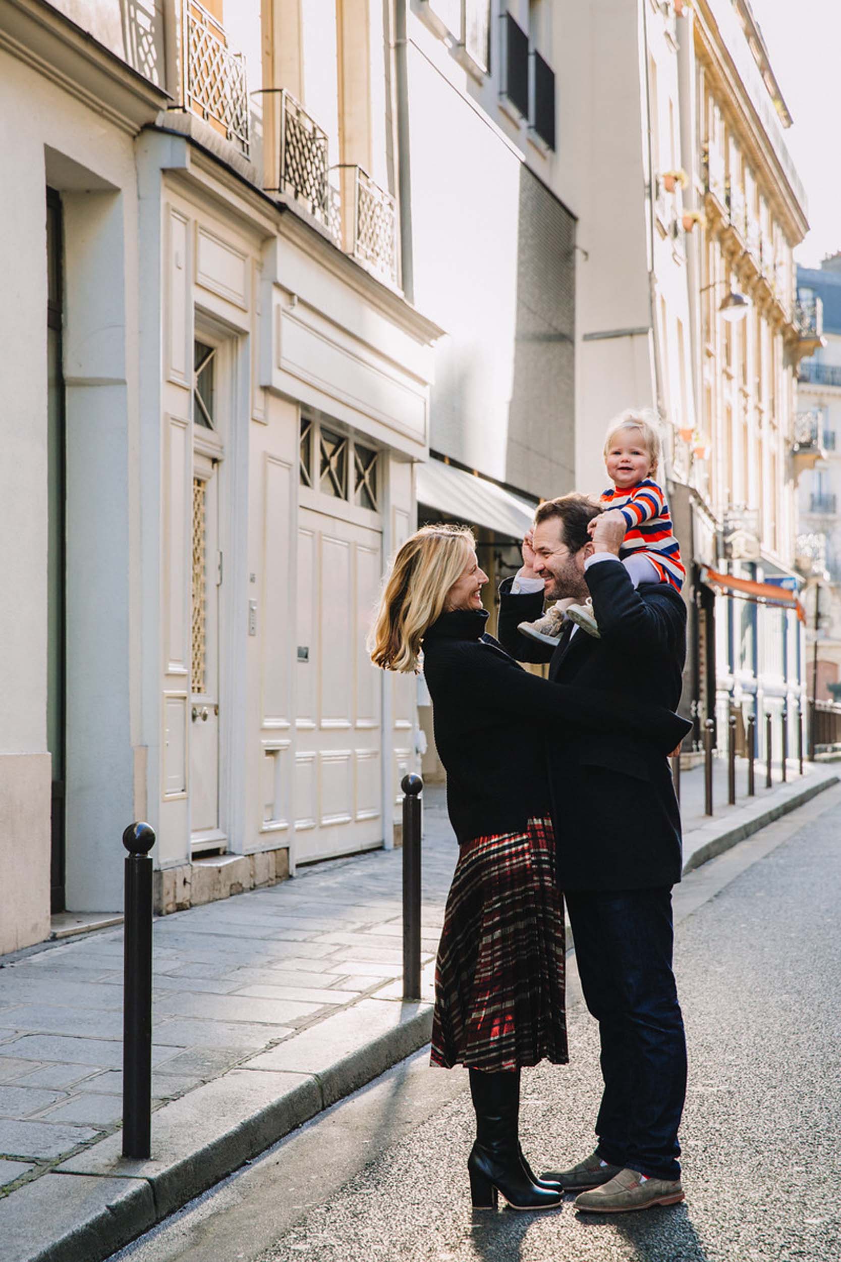 Father and mother with infant daughter in the streets of Paris, France