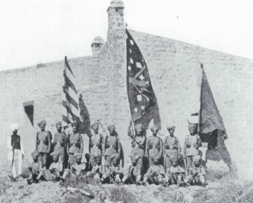 Survivors of the Gulistan sortie party pose with the captured Afridi standards for a photograph by Lt. Col. Haughton. They greeted the relief force by parading these trophies at the gate.