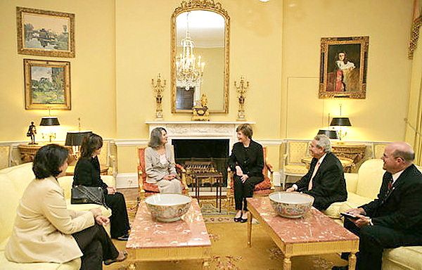Mrs Laura Bush entertaining guests in the Yellow Oval Room...historically this room's always been yellow - the two coffee tables seem a little out of scale in the room