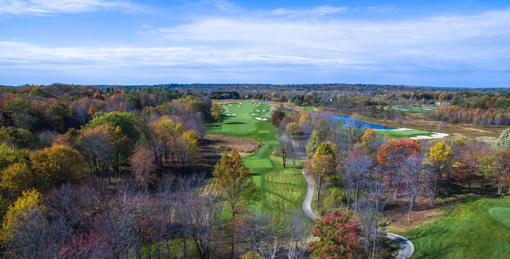 View of Sand Ridge Golf Course shot from a drone just aboe the trees