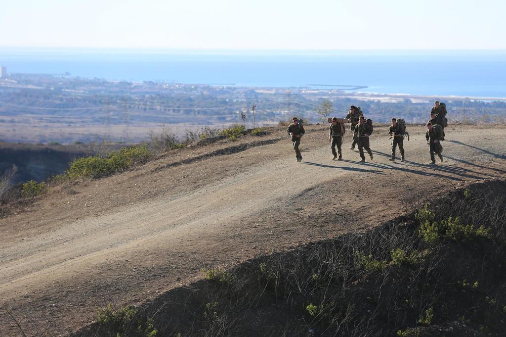 Recon Marines of 1st Force Reconnaissance Company execute an 8 mile ruck run with 50 lb packs photo by Joshua Murray 