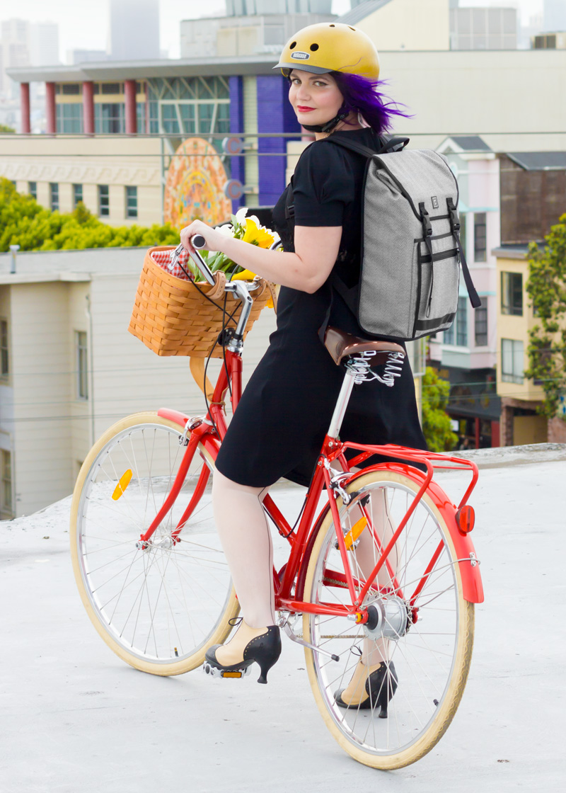 Gold Sparkle Nutcase Helmet | Rickshaw Bags Tweed Backpack | Puff-Sleeve Vintage Inspired Dress | Seamed Tights | Fluevog Two-tone High Heel Oxfords | Papillionaire Step-through Bicycle | Peterboro Basket with Liner