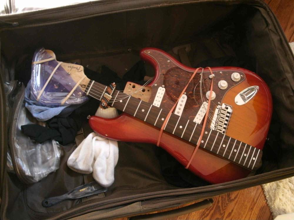 I suppose this is one way to pack your guitar for the trip but I don't recommend this one. 