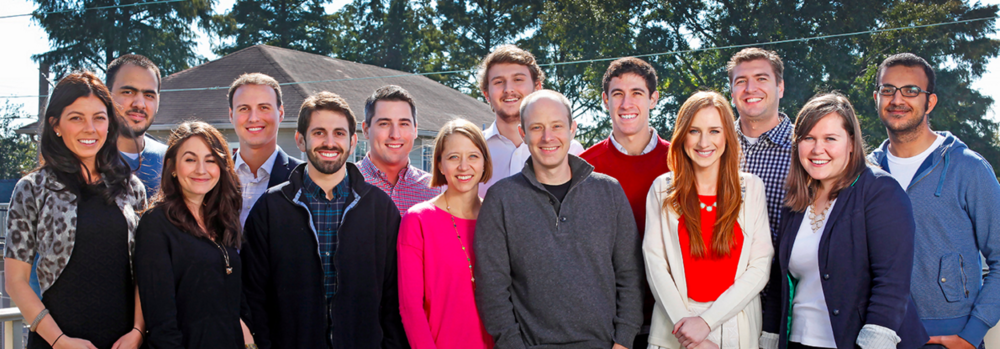 Bigger, easier: Founder Scott Wolfe (center, gray pullover) leads one happy, growing staff in the Crescent City.  