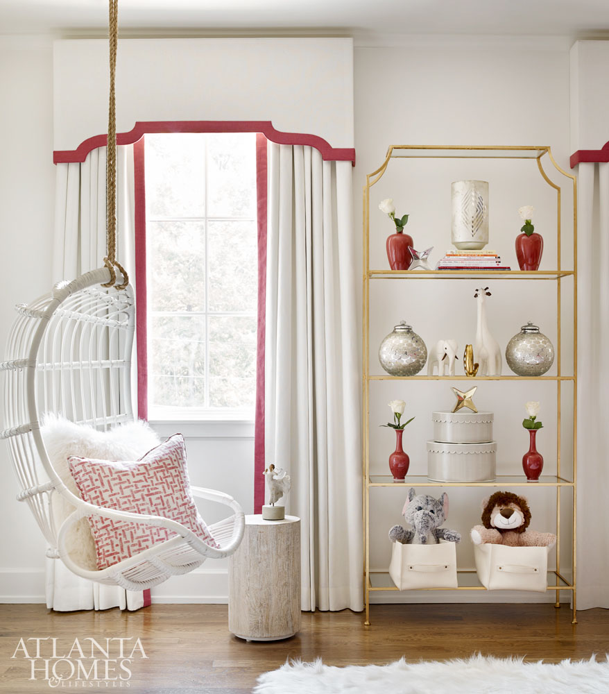 Elegant soft red and white decor in room with white rattan swing - Atlanta show house 2016