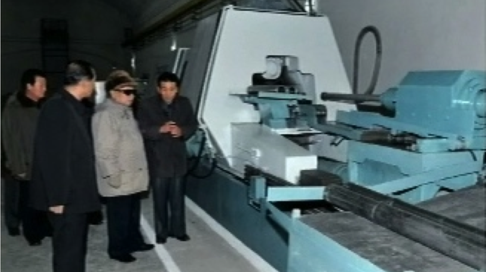 An example of the open-source evidence used for Kemp's study: A 2011 image from a television broadcast in North Korea showing Kim-Jong Il inspecting a flow-forming machine located in an underground tunnel. This type of machine is able to produce centrifuge rotors for North Korea's uranium-enrichment program.