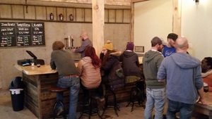  The tasting room is like being in a Maine camp with rugged timbers, tasteful decorative items, and a brick hearth with roaring stove.&nbsp; 