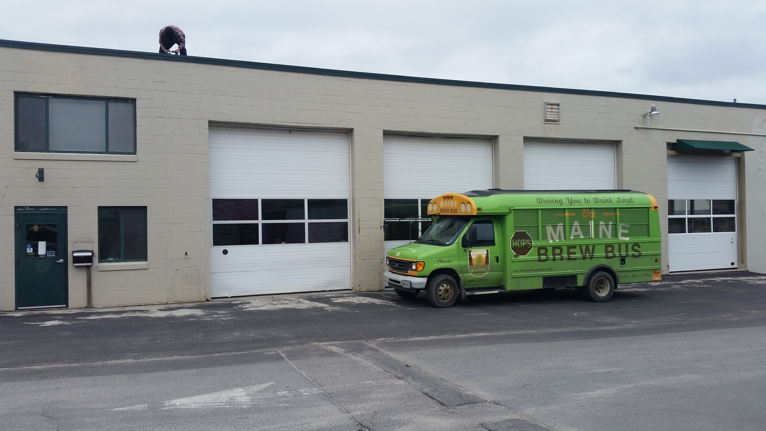  Testing to see how it will look with our buses (we didn't see the guy on the roof until after we took the pic). The building was once part of the Merrill Transport complex and was designed for tractor trailer repair. 