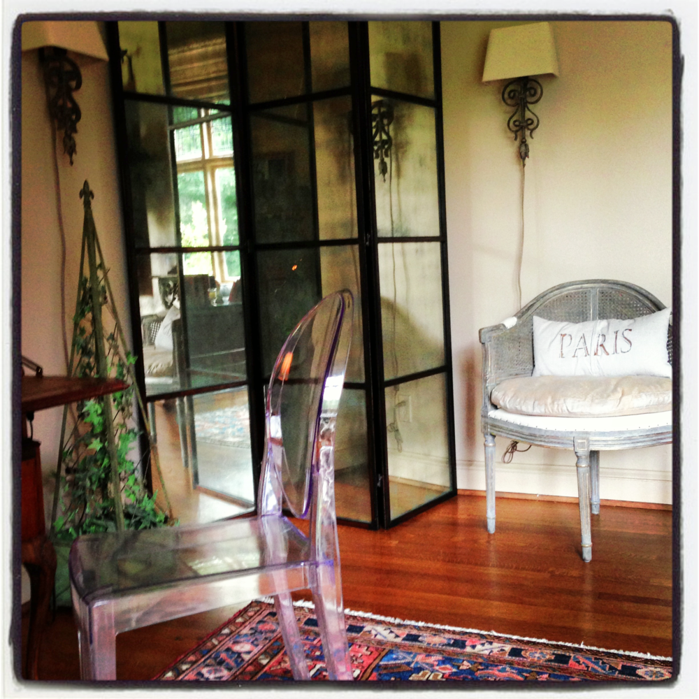 Philippe Starck Ghost Chair mixed with French reproductions and antique Oriental rug
