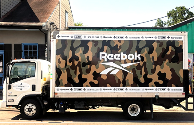 Featured Project- Reebok. Box truck wrapped with camouflage print and Reebok logo.