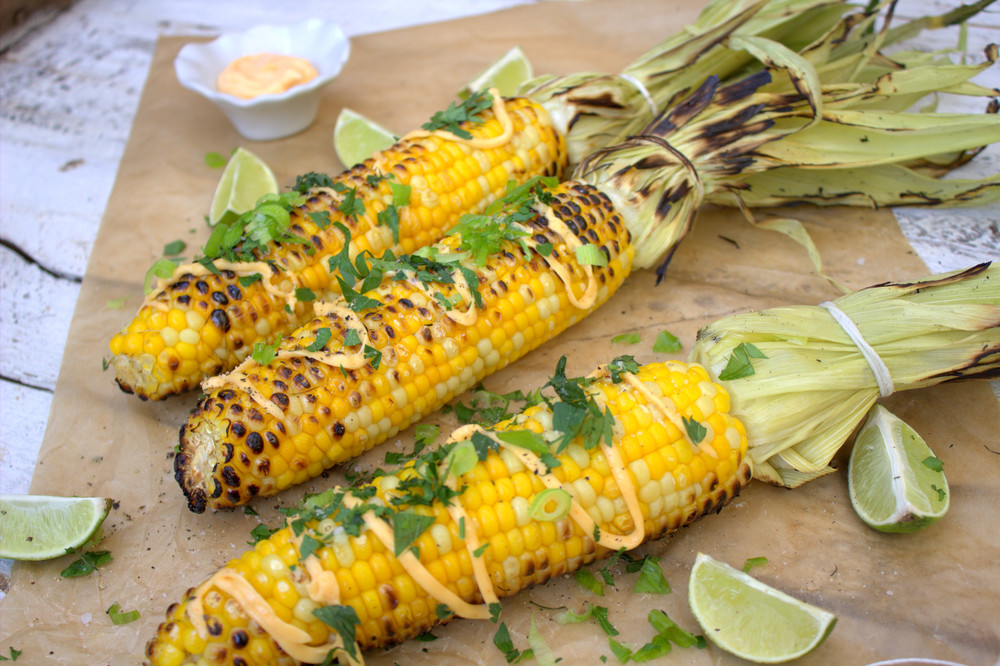 Grilled corn on the cob w cilantro lime and Sriracha mayo Under a  