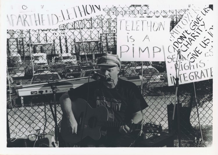 Photo of Johhny Crescendo performing at Block Telephon (1992), deposited by Elspeth Morrison: image produced by  THE-NDACA.ORG &lt; http://the-ndaca.org/ &gt;