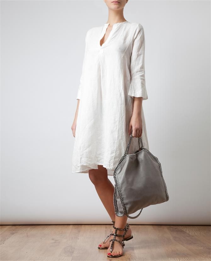 Perfect on a hot summer's day whether walking to work or a  stroll along the avenue this simple white linen tunic complements any age and flatters every figure.