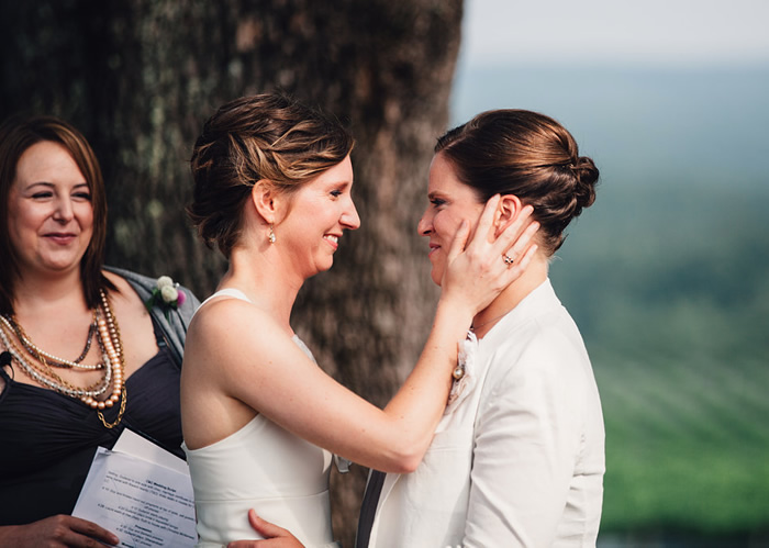 two brides lean in for kiss at end of wedding ceremony richmond virginia