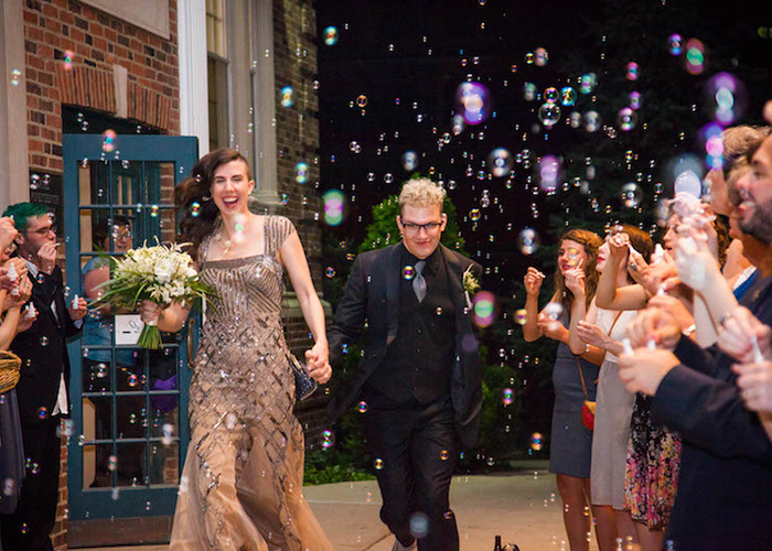newlywed couple surrounded by guests and bubble exit St. Louis Missour