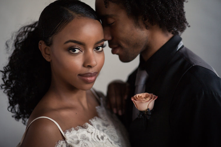 black bride and groom nuzzling foreheads after wedding