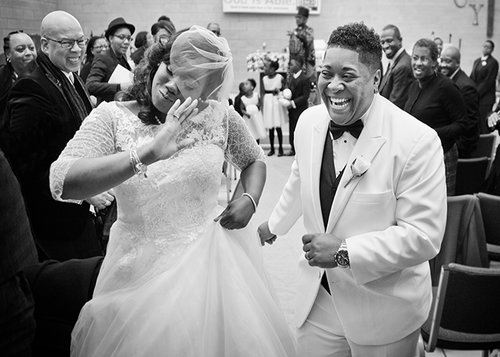 newlywed couple dancing down the aisle after their wedding maryland