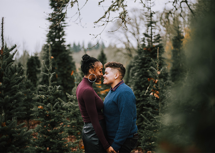 engaged couple embraced in the forest portland oregon