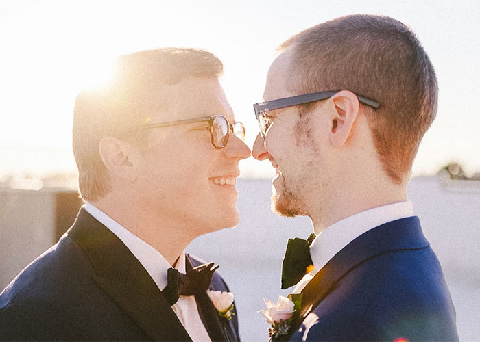 two grooms touch noses at wedding philadelphia pennsylvania