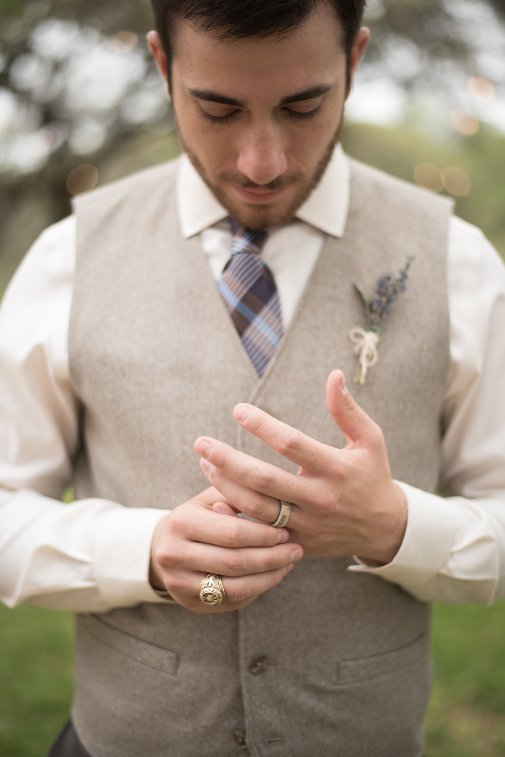 man looking down at his wedding ring