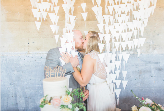 couple kissing after cake cutting
