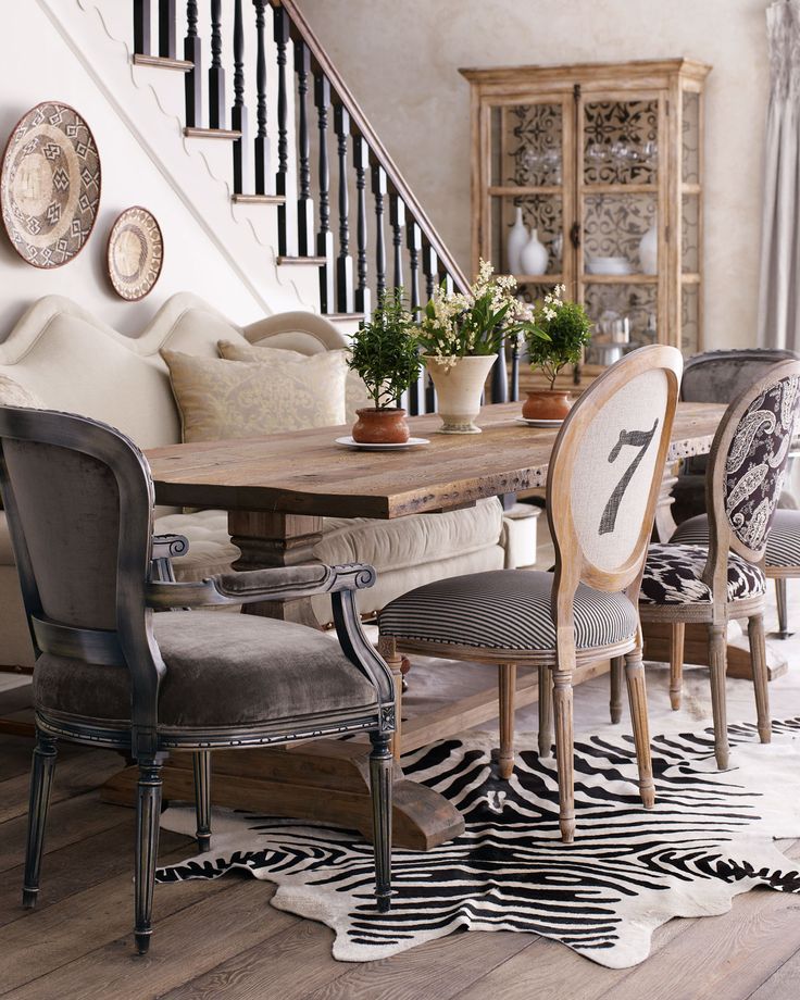 mismatched chairs around a dining table 