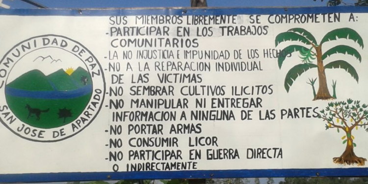  Entry sign stating the principles of San JosÃ© de Apartadoâs Peace Community. 
