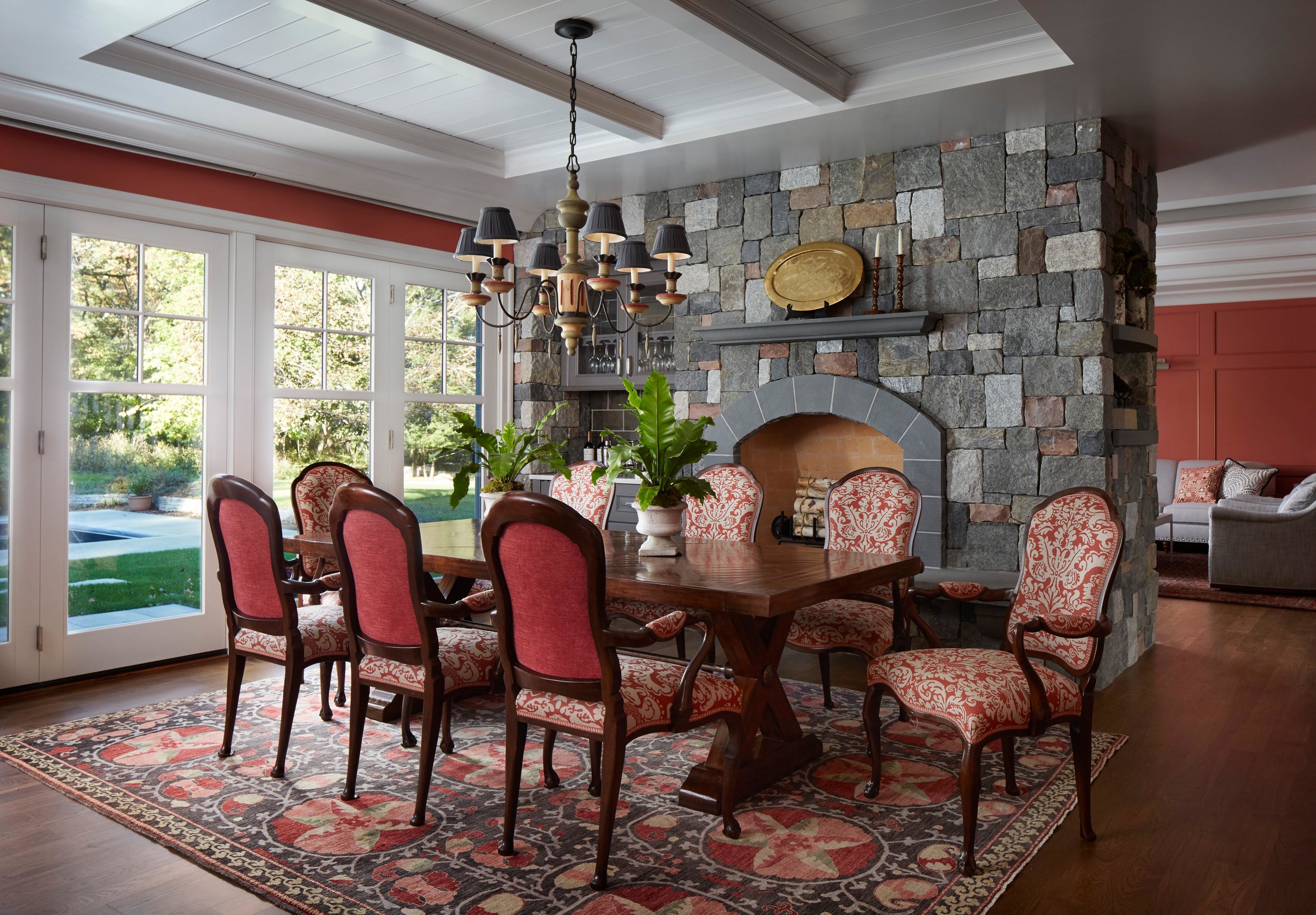 Coral walls and accents in a classic dining room with fireplace. Come see more interior design inspiration from Elizabeth Drake. Photo by Werner Straube. #interiordesign #classicdesign #traditionaldecor #housetour #elizabethdrake