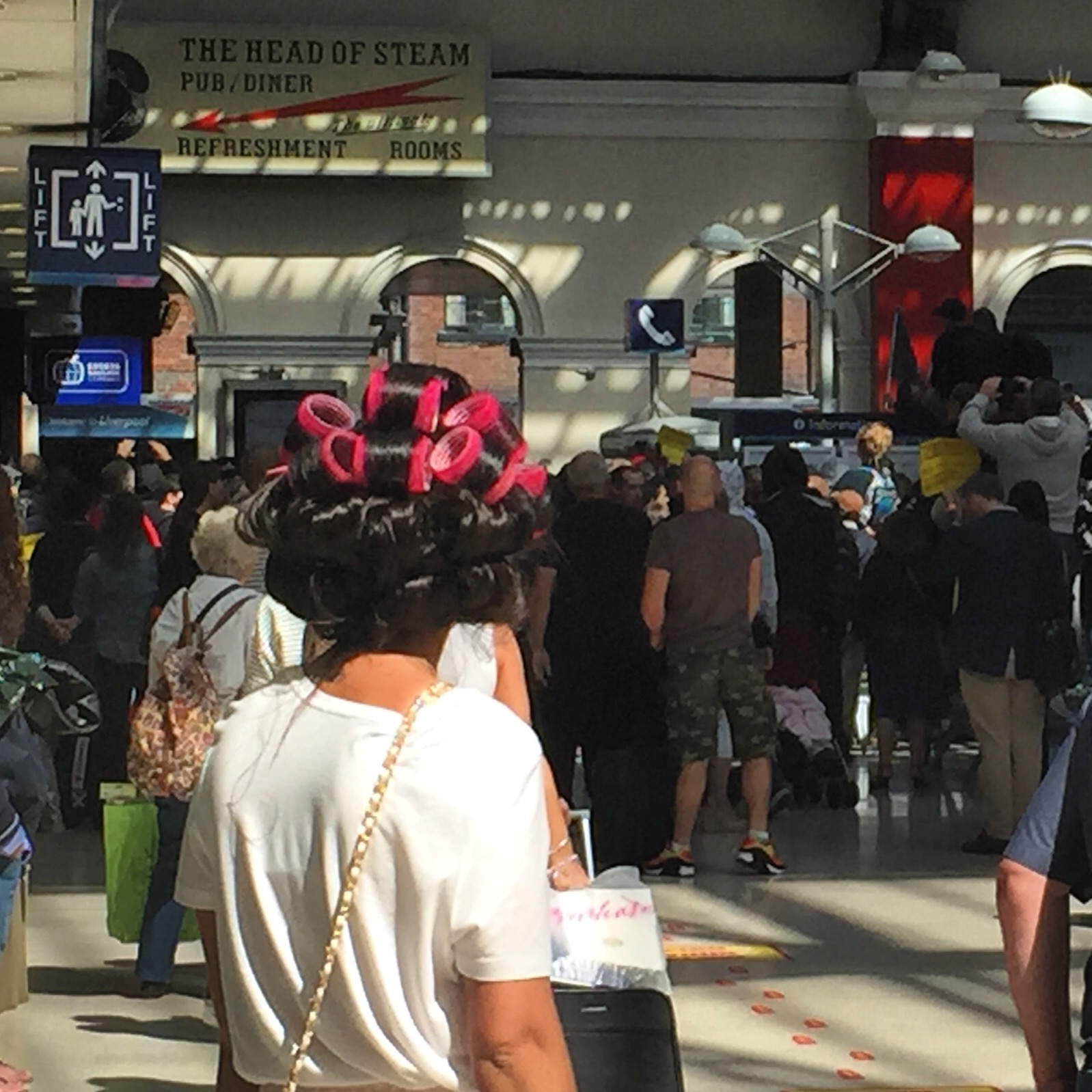  A girl with hair in rollers watches on as police battle to calm a clash between white supremacists and anti-fascism protesters at Liverpool Lime Street Station in August, 2015. Pic copyright @jabberingjourno 