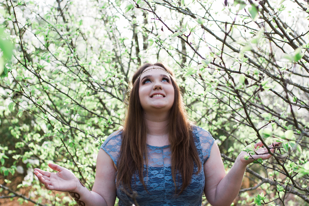 Hannah Looking up to the Sky with her hands reaching. Senior Picture