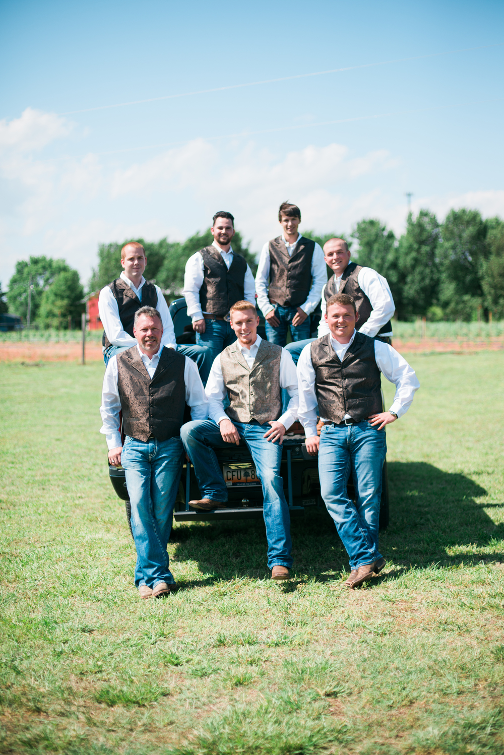 Groom, Best Man and Grooms men sitting on a pickup truck