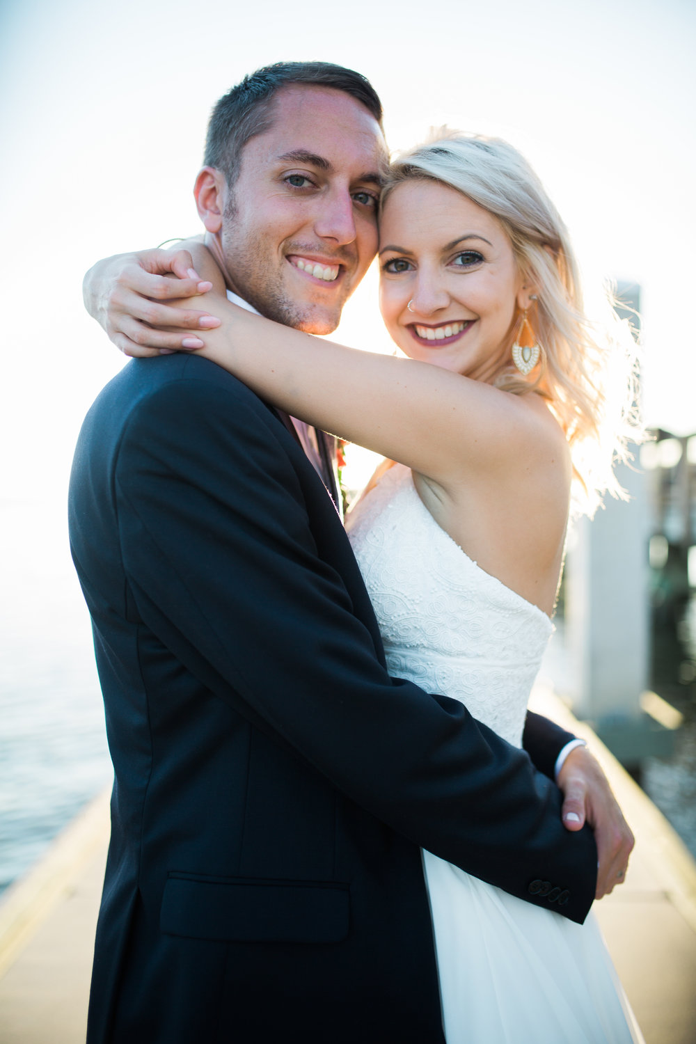 Smiling Bride and Groom with arms around each other