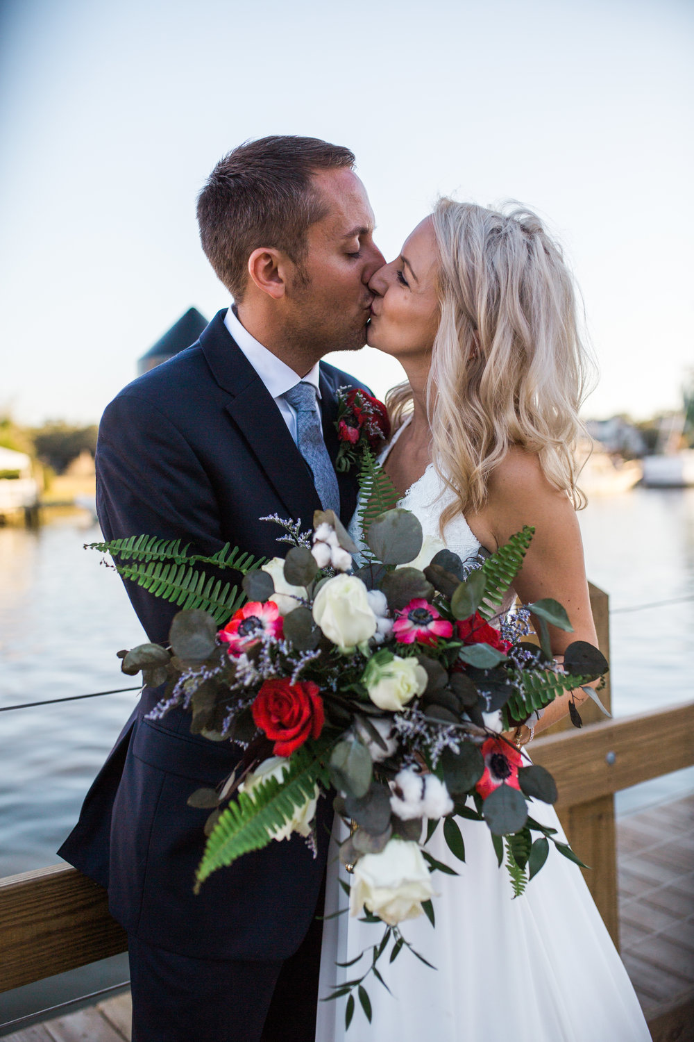 Bride and Groom kissing by water