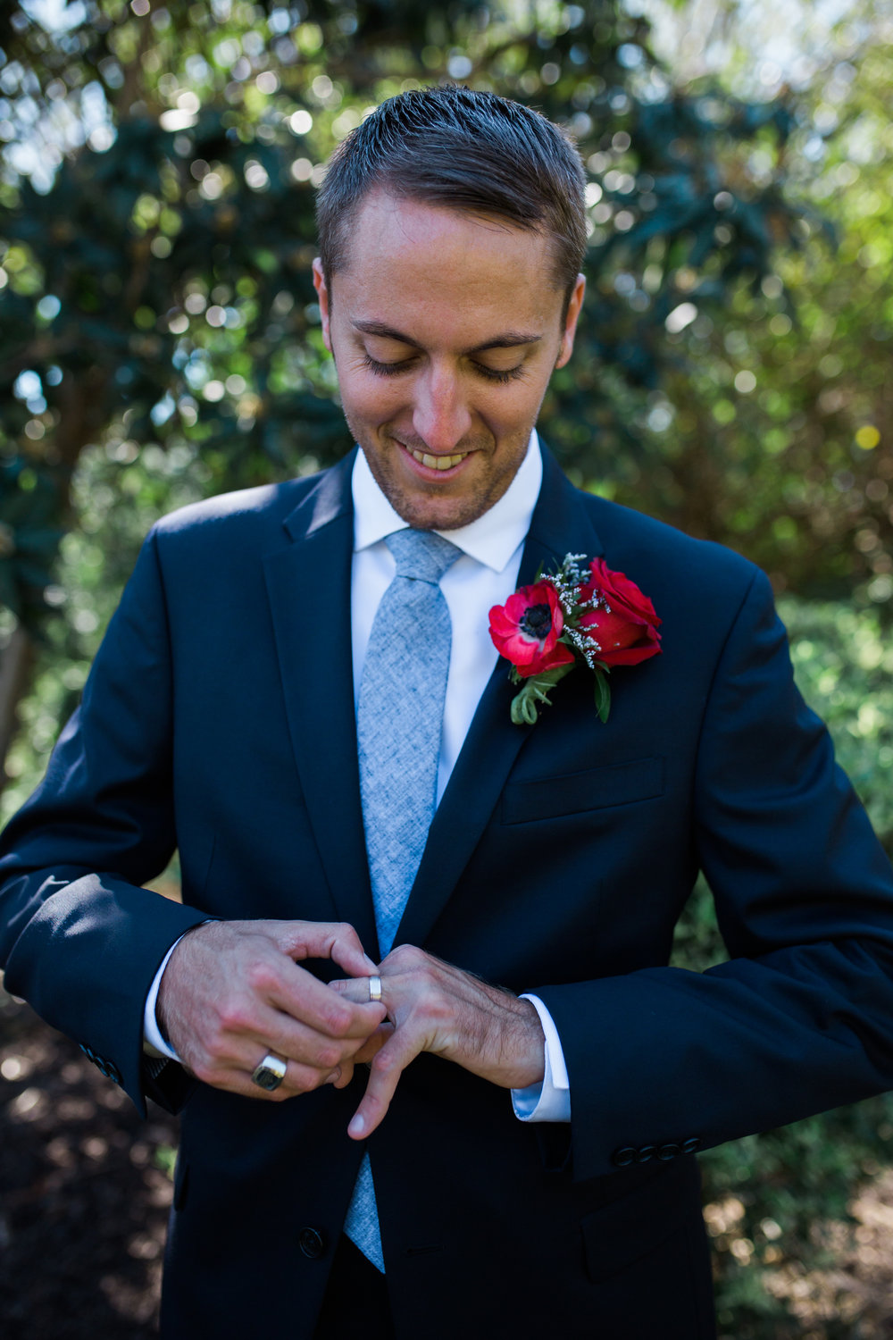 Groom playing with wedding ring before ceremony
