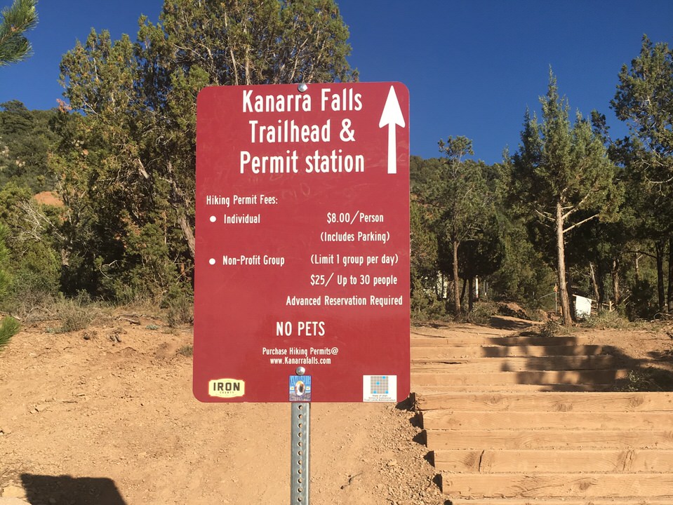 Trailhead sign at Kanarra Falls showing the permit fees for this trail.