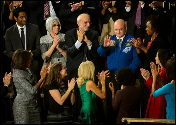 NASA astronaut Scott Kelly stands as he is recognized by President Barack Obama. Astronaut Scott Kelly will launch to the International Space Station and become the first American to live and work aboard the orbiting laboratory for a year-long mission. Credit: NASA/Bill Ingalls