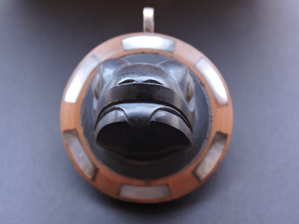 Front view of this argillite pendant with a sterling silver bail
