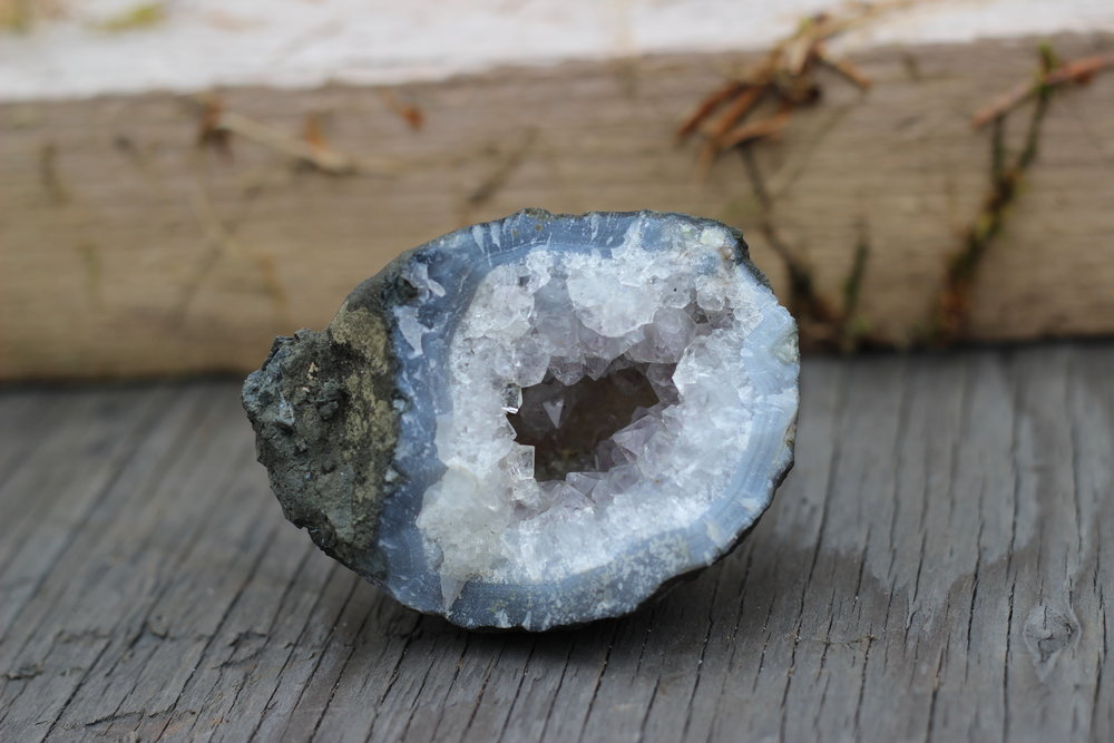 This smaller geode has a quartz crystal centre with a small amount of amethyst colouring. Blue banded agate surrounds the crystal interior. This specimen is from Haida Gwaii.&nbsp;