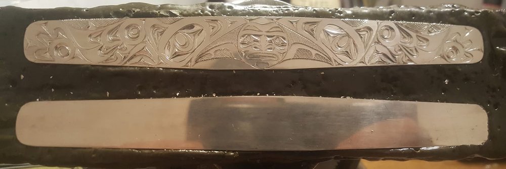 This beautiful work in progress was created by the well known Haida artist James Sawyer. It is 2 inches wide by 7 inches long and features two ravens stealing the moon and is carved in sterling silver.