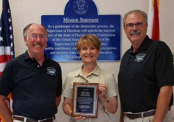 Supervisor of Elections Vicki Davis (center) receiving an award from the Deaf and Hard of Hearing Services. Photo courtesy of Martin County Elections Center.