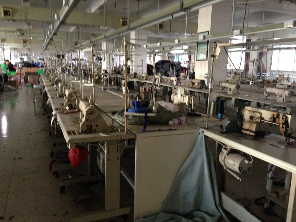 Many empty sewing machines ready to be manned in the high peak season