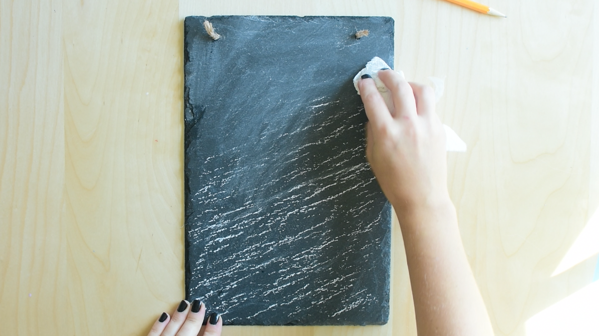 Prep chalkboard surface by spreading chalk all over it