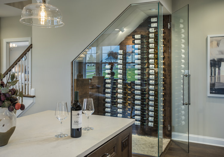 Creative floor plan with glass wine storage under stairwell in WB Homes.