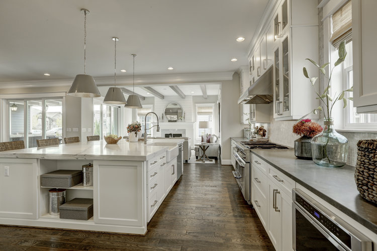 Design trend of sophisticated farmhouse white kitchen and wood floor.