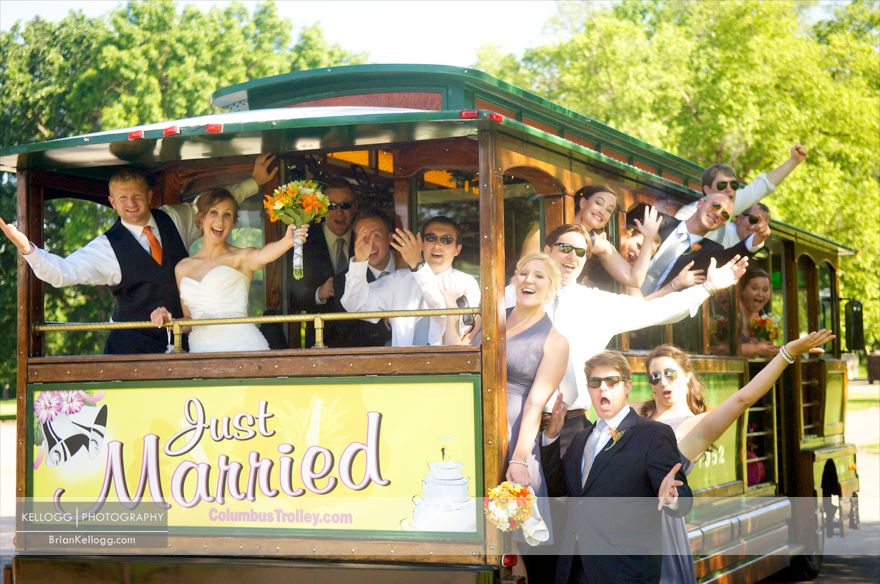 Wedding Party hanging off Trolly Photo