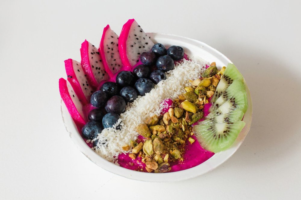 Sup-Succa 14; Pitaya, coconut milk, strawberries, mango, agave. Topped with kiwi, dragonfruit, coconut flakes, pistachios, and edible flowers.