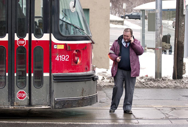 A Toronto streetcar driver stops for a smoke break in front of his streetcar