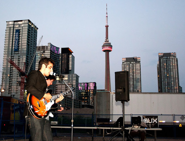CN Tower in the background of an Indie band playing