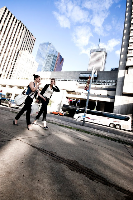 Two young ladies walking down Queen Street in Toronto